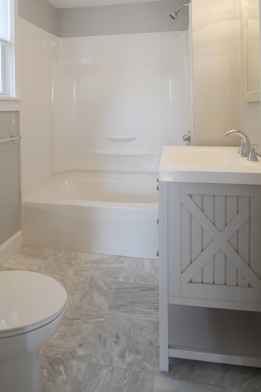 62 Eastern Point Road, Unit 1 Gloucester, MA 01930 - Photo 16 of 20 a bathroom with a sink a toilet and shower