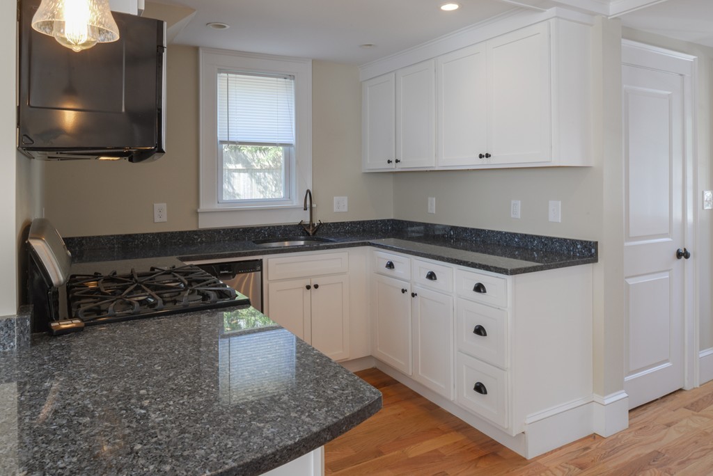 62 Eastern Point Road, Unit 1 Gloucester, MA 01930 - Photo 3 of 20 a kitchen with granite countertop a stove and a sink