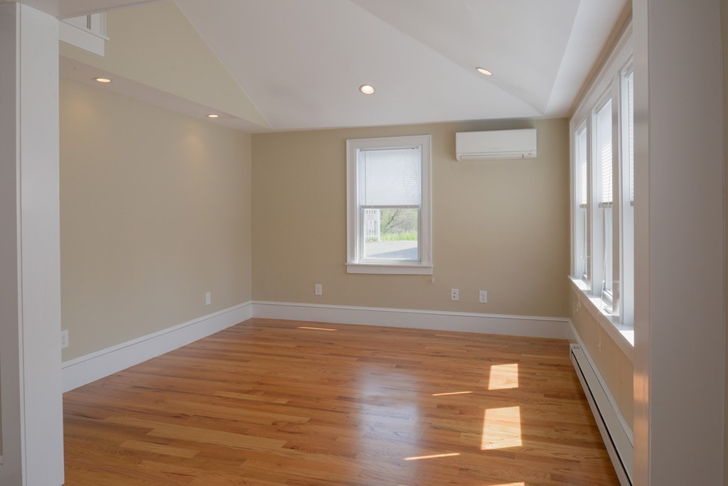 62 Eastern Point Road, Unit 1 Gloucester, MA 01930 - Photo 7 of 20 a view of empty room with wooden floor and fan