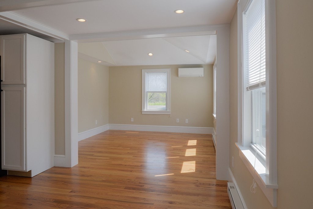 62 Eastern Point Road, Unit 1 Gloucester, MA 01930 - Photo 8 of 20 a view of empty room with wooden floor and fan