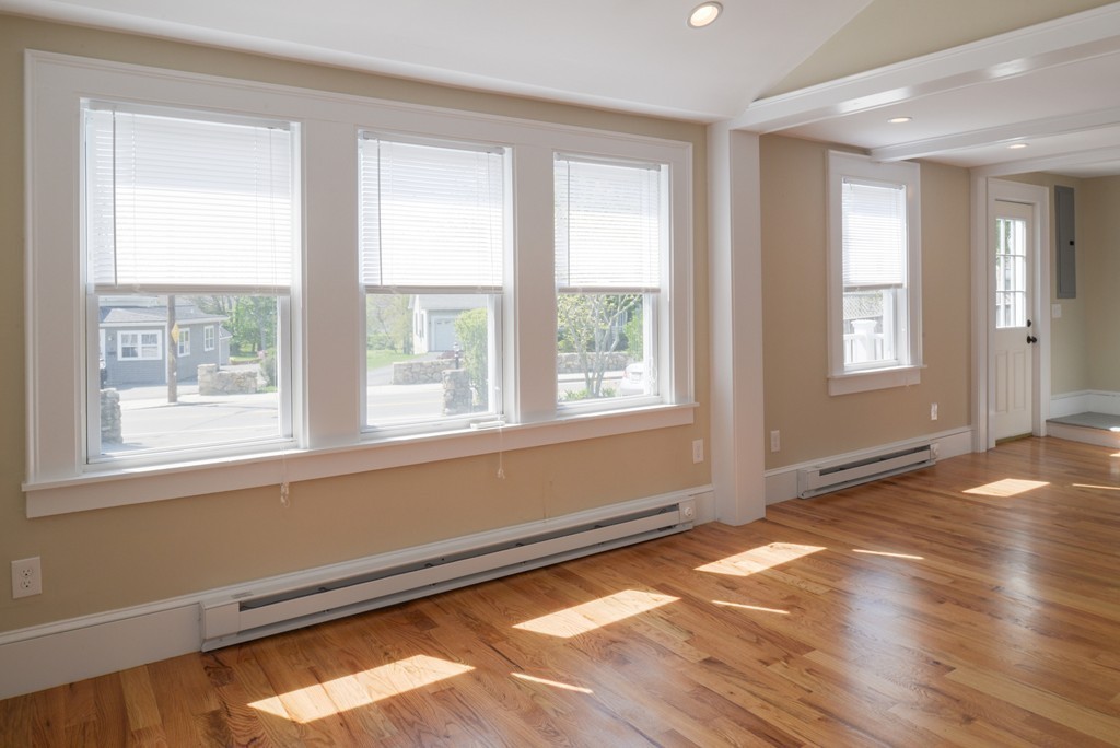 62 Eastern Point Road, Unit 1 Gloucester, MA 01930 - Photo 9 of 20 a view of an empty room with wooden floor and a window