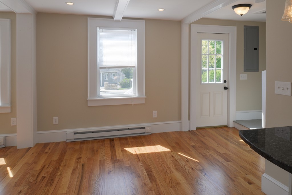 62 Eastern Point Road, Unit 1 Gloucester, MA 01930 - Photo 10 of 20 an empty room with wooden floor and windows
