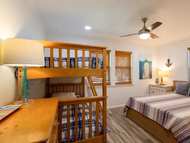 a bedroom with a bed a window and a chandelier