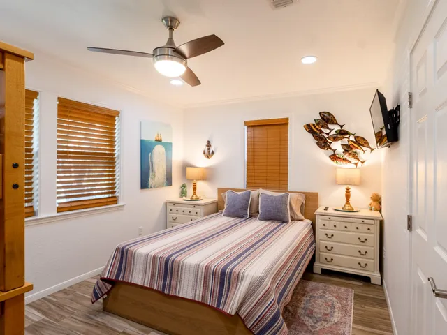 a view of a patio with a table and chairs under an umbrella