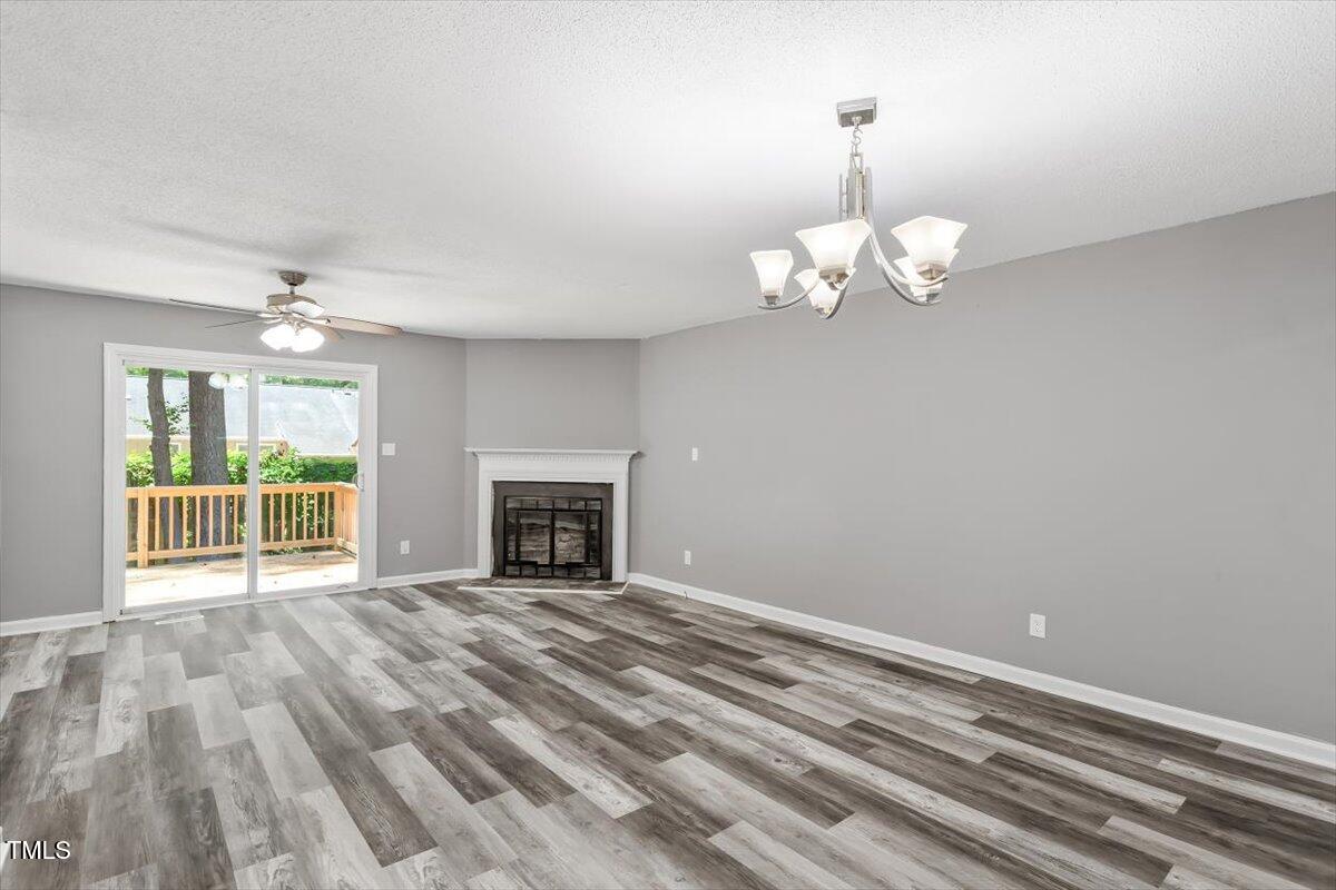 9 Tarawa Terrace, Unit A Durham, NC 27705 - Photo 2 of 12 a view of an empty room with wooden floor fireplace and a window