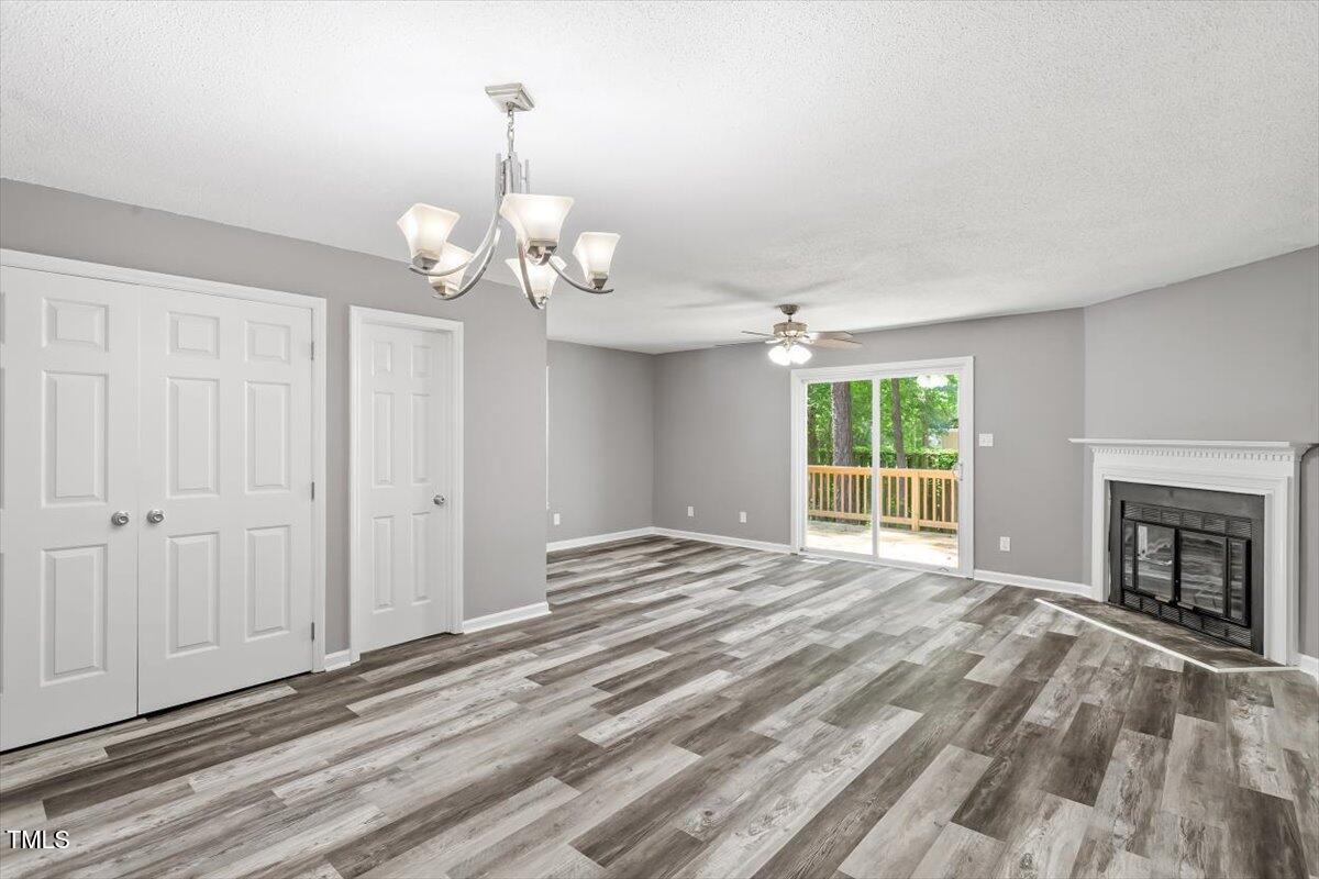 9 Tarawa Terrace, Unit A Durham, NC 27705 - Photo 3 of 12 a view of an empty room with a fireplace and a window