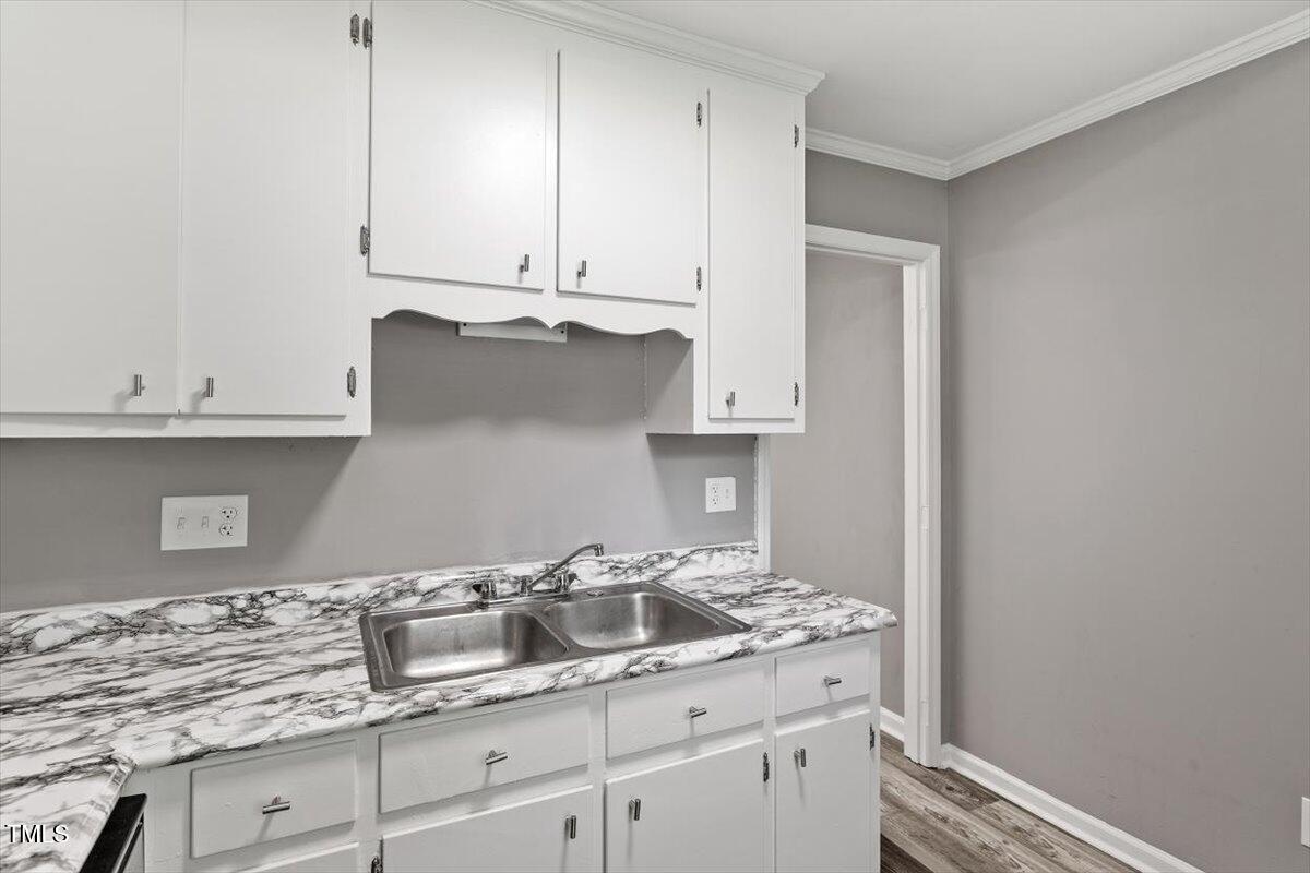 9 Tarawa Terrace, Unit A Durham, NC 27705 - Photo 4 of 12 a kitchen with granite countertop white cabinets and a sink