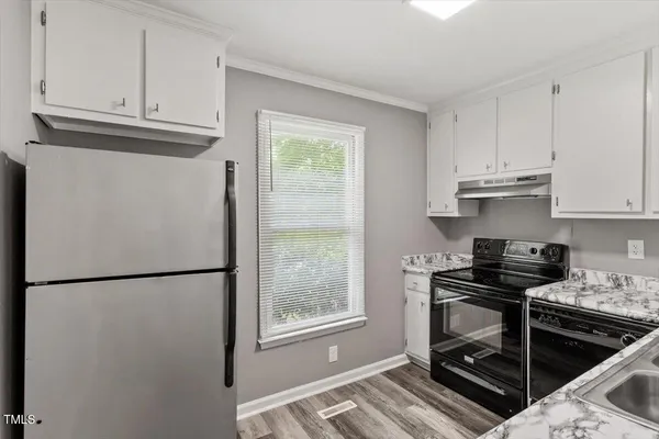 a kitchen with stainless steel appliances granite countertop a refrigerator sink and cabinets