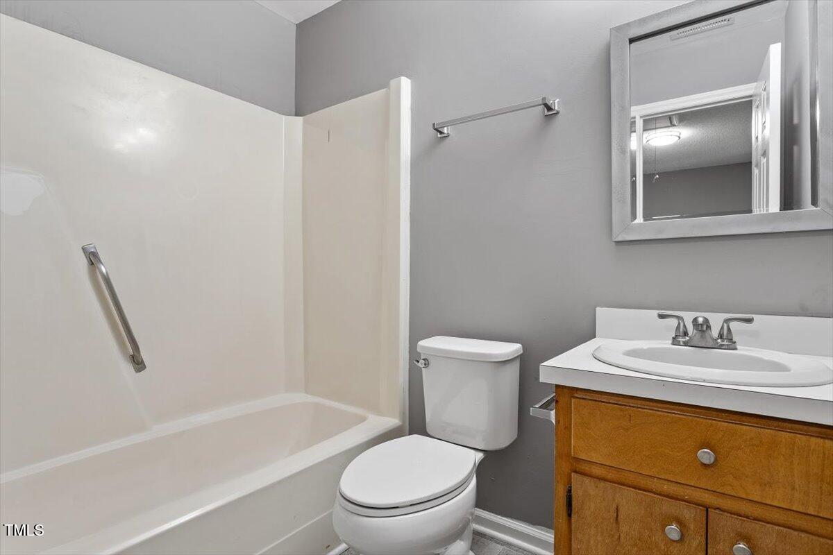 9 Tarawa Terrace, Unit A Durham, NC 27705 - Photo 6 of 12 a bathroom with a sink a toilet and shower
