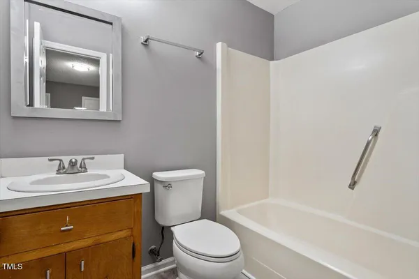 a bathroom with a sink a toilet and bathtub