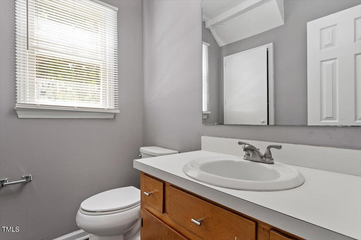 9 Tarawa Terrace, Unit A Durham, NC 27705 - Photo 10 of 12 a bathroom with a sink a toilet and a mirror
