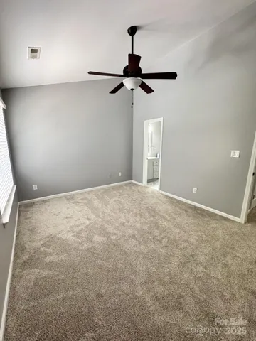 an empty room with a fan