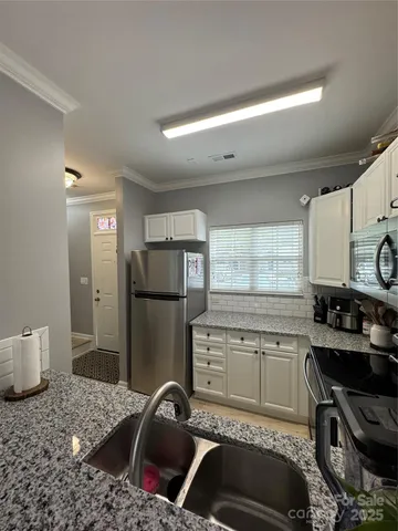 a kitchen with a sink appliances and cabinets