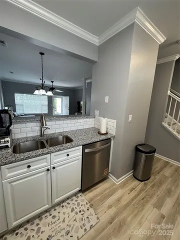 a kitchen with stainless steel appliances granite countertop a sink and a stove