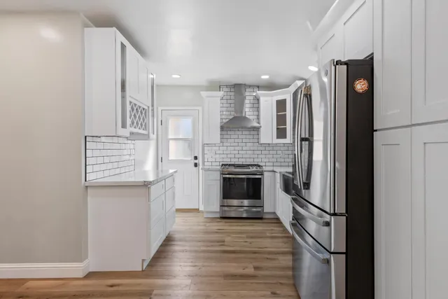 a view of kitchen with sink and refrigerator