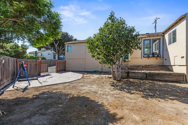 a view of a backyard with a tree