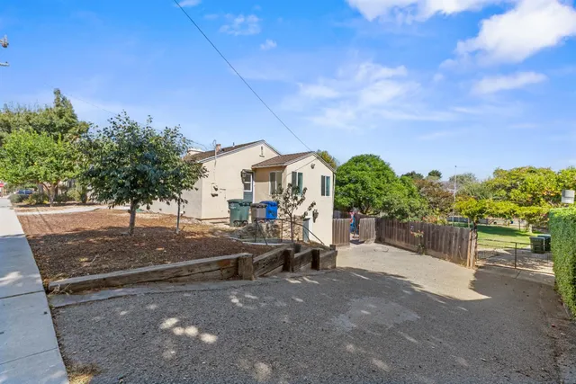 a view of a street with a cars parked