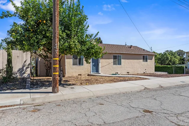 a front view of a house with a road and yard