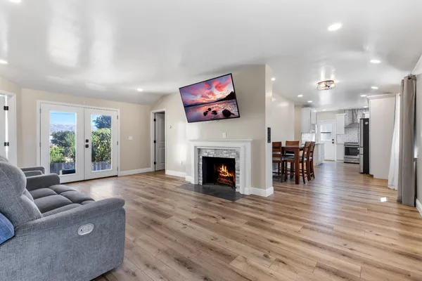 a living room with furniture a fireplace and a flat screen tv