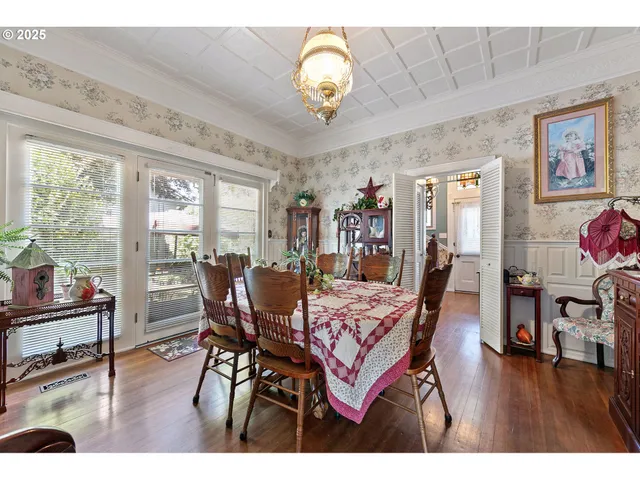a view of a dining room with furniture wooden floor and chandelier