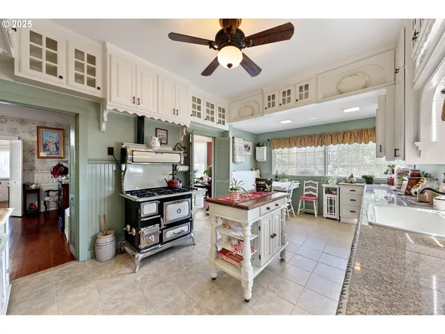 a living room with stainless steel appliances kitchen island granite countertop furniture and a kitchen view