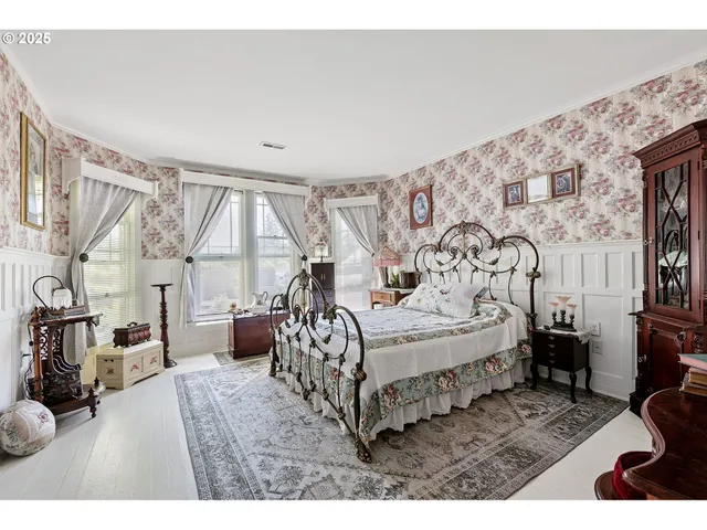 a bedroom with a bed with window