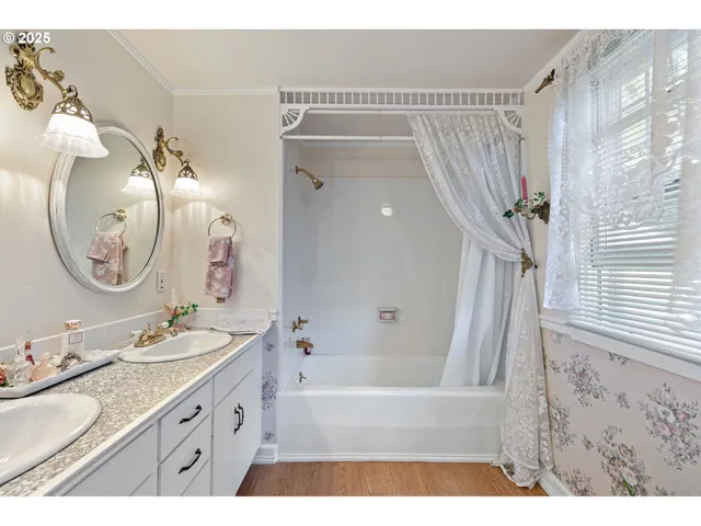 a bathroom with a granite countertop sink mirror and a bathtub
