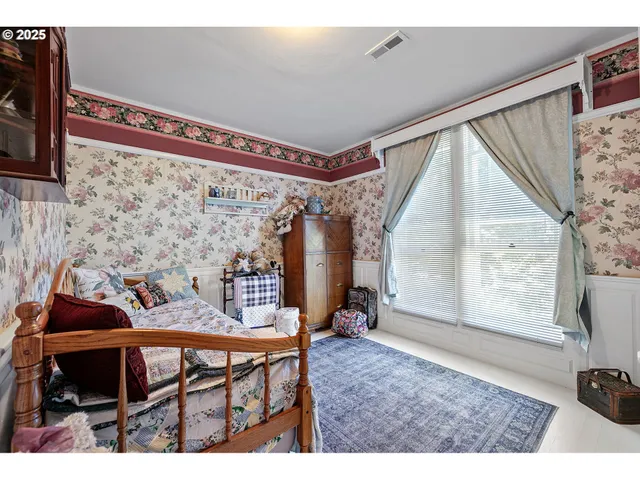 a view of a dining room with furniture and a window
