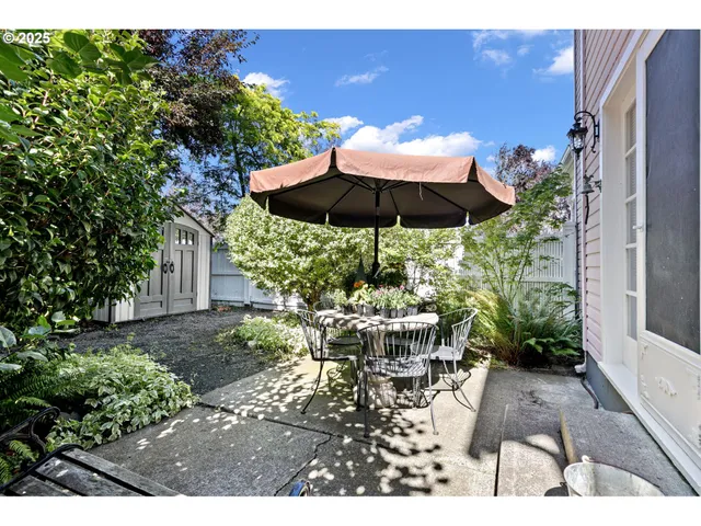 a view of a patio with chairs and potted plants