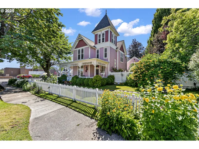 a view of a house with a small yard and potted plants
