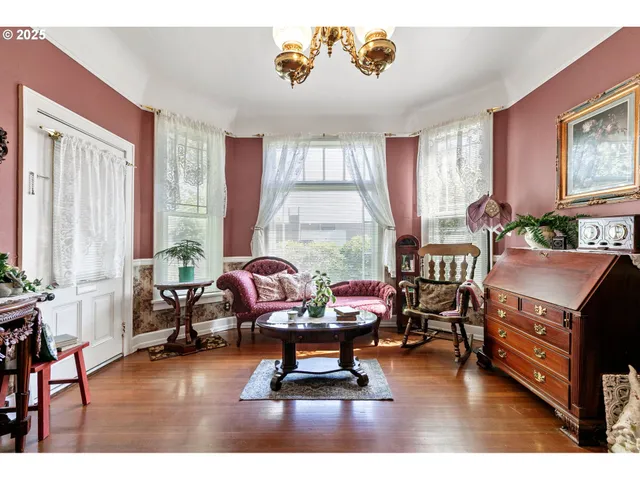 a living room with furniture and large windows