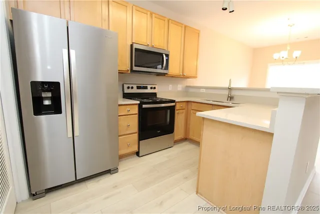 a kitchen with stainless steel appliances a refrigerator stove and microwave