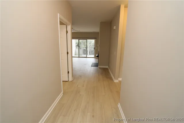 a view of a room with wooden floor and a window