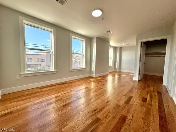 a view of a room with wooden floor