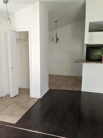 a view of a room with wooden floor and a sink