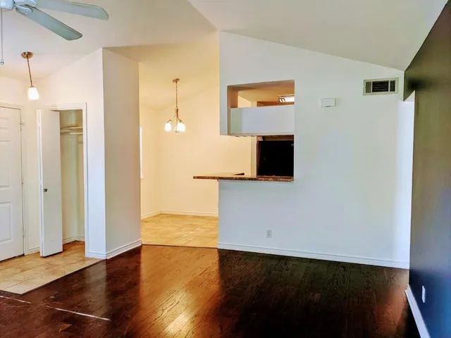 a view of a kitchen with wooden floor and a cabinet
