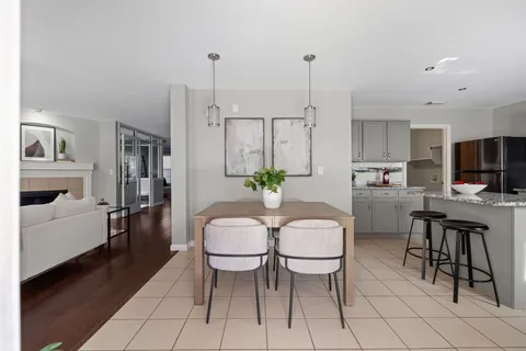 a living room with furniture a fireplace and a chandelier