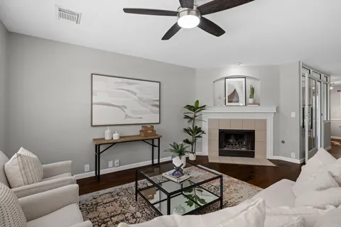 a living room with furniture a window and a fireplace