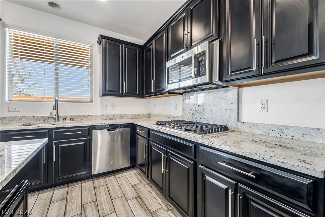 6245 Andover Wood Road Las Vegas, NV 89113 - Photo 13 of 37 Culinary delights await in this modern kitchen with extensive counter space and sleek appliances.