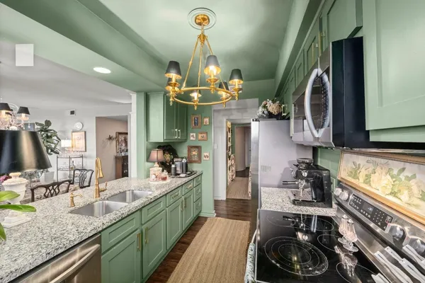 a kitchen with sink stove and cabinets