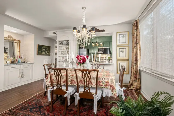 a view of a dining room with furniture and chandelier