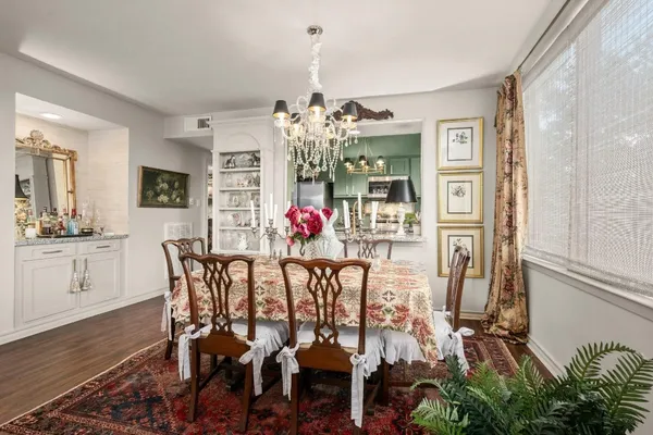a view of a dining room with furniture and chandelier