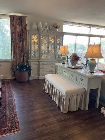 a bedroom with a bed and large windows