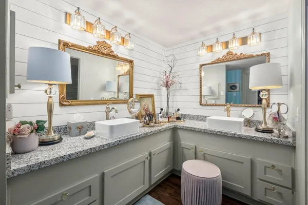 a bathroom with a granite countertop sink and a mirror
