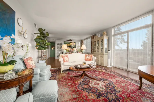 a living room with furniture or couch and a floor to ceiling window