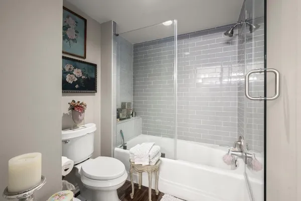 a bathroom with a toilet and a shower