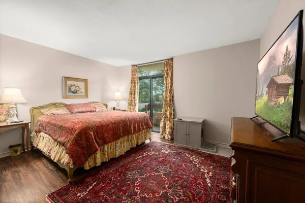 a bedroom with a bed and a flat screen tv