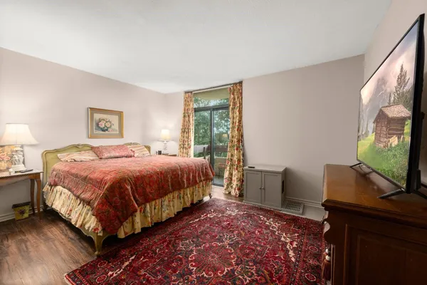 a bedroom with a bed and a flat screen tv