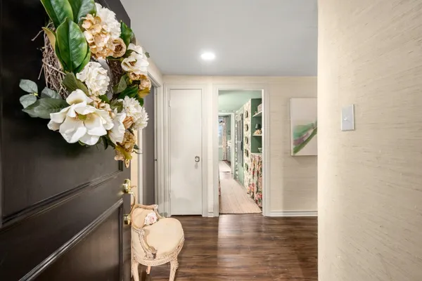 a view of a hallway with wooden floor