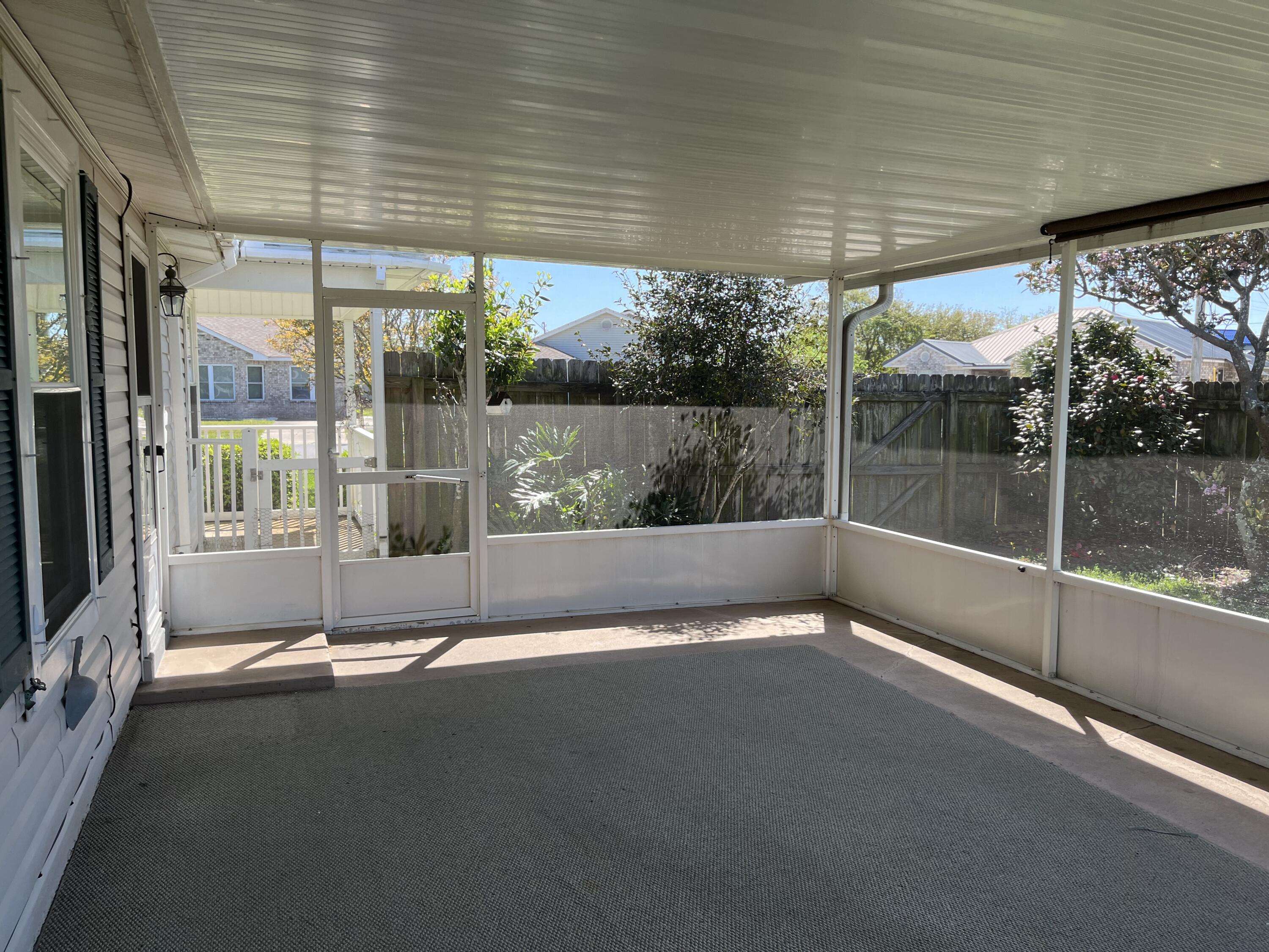 2260 Estate Circle Navarre, FL 32566 - Photo 13 of 14 a view of a patio with a table and chairs